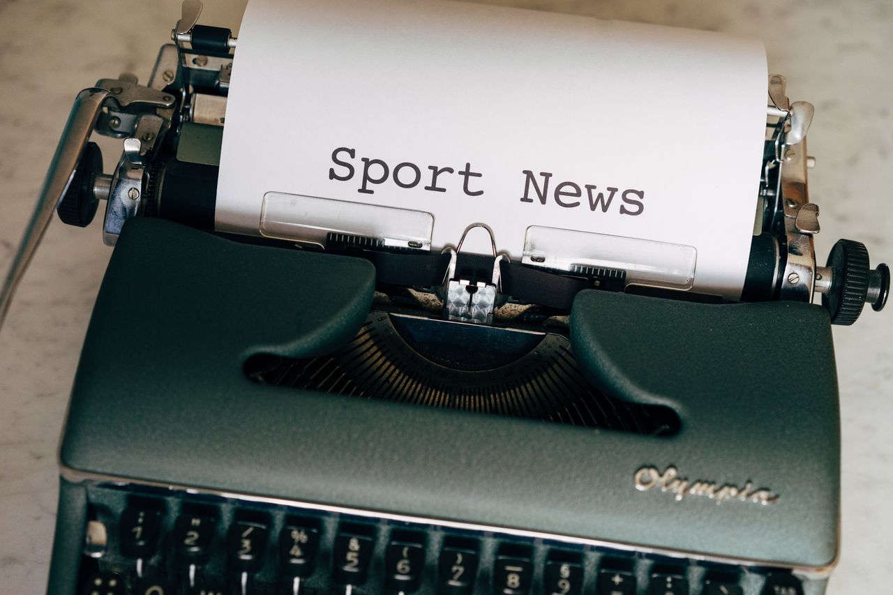 Welcome to Negative Marketing Close-up of a vintage typewriter with a paper showing 'Sport News', evoking nostalgia and classic journalism.